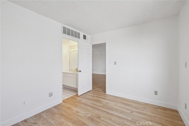 10966 Rochester Ave Unit 5D, Los Angeles, CA 90024 - spare room with baseboards, light wood-type flooring, and visible vents