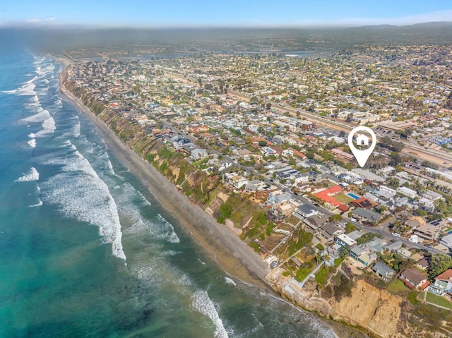 aerial view featuring a residential view, a view of the beach, and a water view