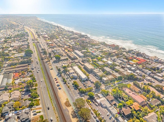 drone / aerial view featuring a water view and a beach view