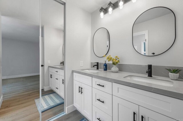 149 W Glaucus St Unit D, Encinitas, CA 92024 - full bathroom featuring double vanity and wood finished floors