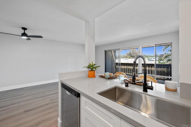 149 W Glaucus St Unit D, Encinitas, CA 92024 - kitchen featuring stainless steel dishwasher, white cabinetry, light wood-type flooring, light countertops, and a ceiling fan