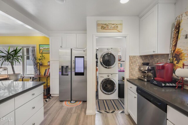 1318 N Marengo Ave, Pasadena, CA 91103 - kitchen with stainless steel appliances, stacked washer and clothes dryer, dark countertops, white cabinets, and tasteful backsplash