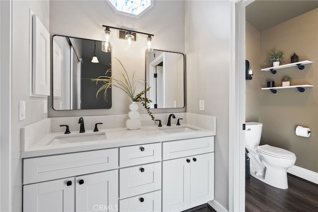 3 Treethorne Cir, Laguna Niguel, CA 92677 - bathroom featuring double vanity, toilet, a sink, and wood finished floors