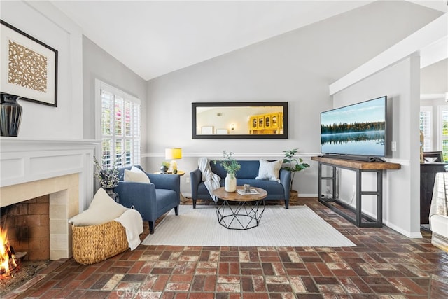 3 Treethorne Cir, Laguna Niguel, CA 92677 - living area featuring brick floor, a warm lit fireplace, a healthy amount of sunlight, and lofted ceiling