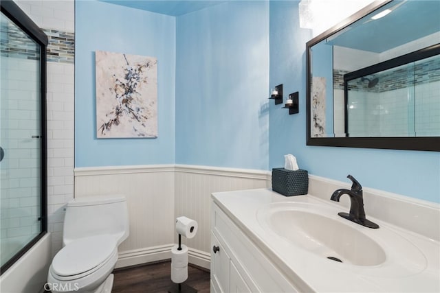 3 Treethorne Cir, Laguna Niguel, CA 92677 - bathroom with wainscoting, wood finished floors, vanity, combined bath / shower with glass door, and toilet
