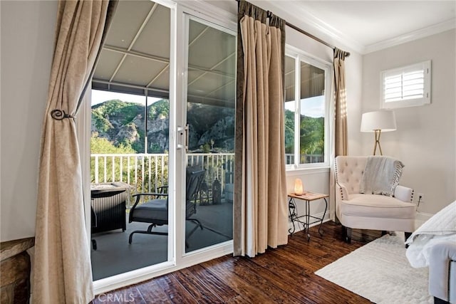 interior space with ornamental molding and wood finished floors