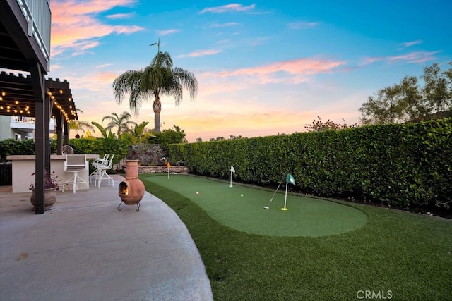 view of community featuring a fenced backyard, outdoor dry bar, and a patio