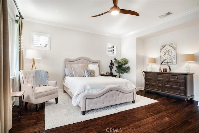 bedroom with visible vents, ornamental molding, baseboards, and dark wood-type flooring