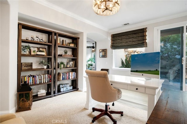 carpeted home office with visible vents, crown molding, an inviting chandelier, baseboards, and arched walkways