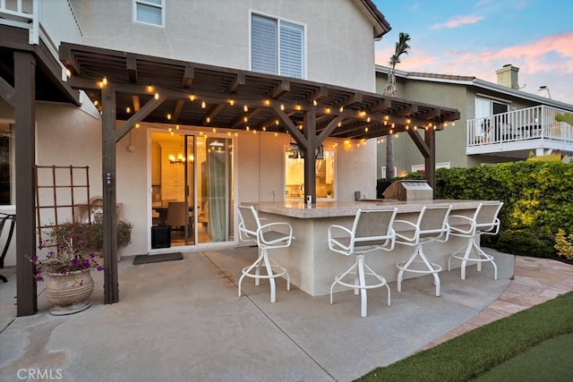 patio terrace at dusk with outdoor wet bar