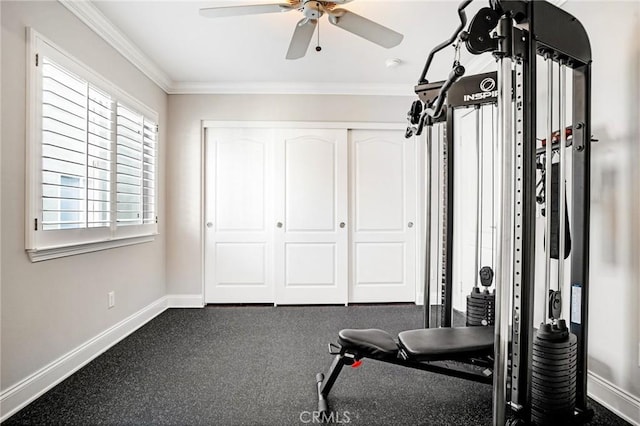 exercise area featuring baseboards, ornamental molding, and a ceiling fan