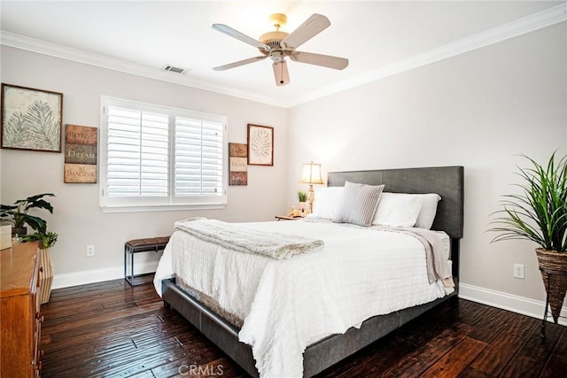 bedroom with baseboards, ornamental molding, and dark wood finished floors