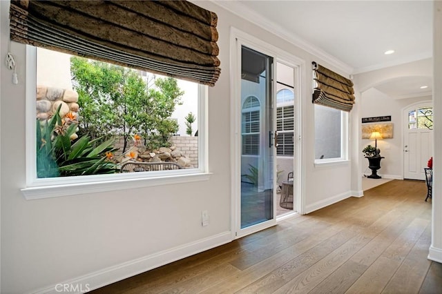 26238 Beecher Ln, Stevenson Ranch, CA 91381 - doorway to outside with hardwood / wood-style flooring, ornamental molding, and arched walkways