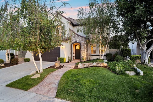 view of front of home with a garage, a front lawn, stone siding, stucco siding, and concrete driveway
