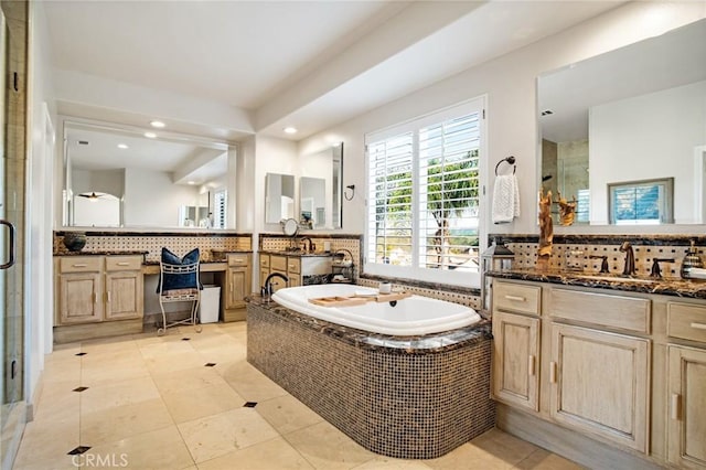 full bath featuring a sink, backsplash, a bath, and a shower stall