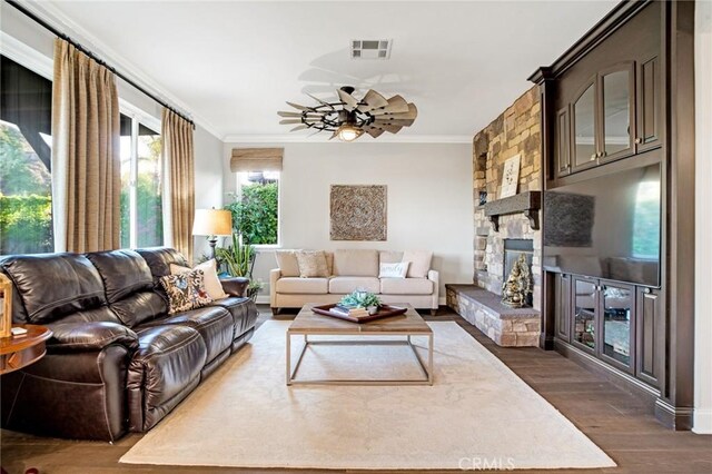 26238 Beecher Ln, Stevenson Ranch, CA 91381 - living area with dark wood-style floors, a ceiling fan, ornamental molding, and a fireplace
