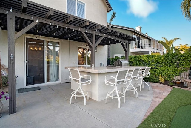 view of patio / terrace with a pergola and outdoor dry bar