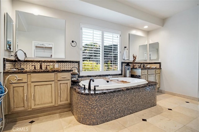 26238 Beecher Ln, Stevenson Ranch, CA 91381 - bathroom featuring two vanities, a garden tub, tile patterned flooring, backsplash, and recessed lighting