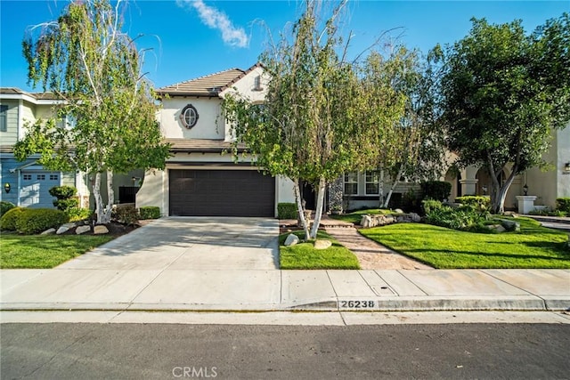 view of front facade with an attached garage, a tile roof, stucco siding, a front yard, and concrete driveway