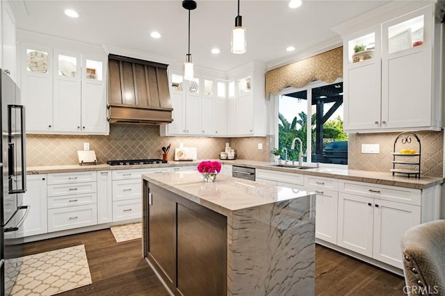 26238 Beecher Ln, Stevenson Ranch, CA 91381 - kitchen featuring premium range hood, gas stovetop, dark wood-type flooring, white cabinets, and a center island