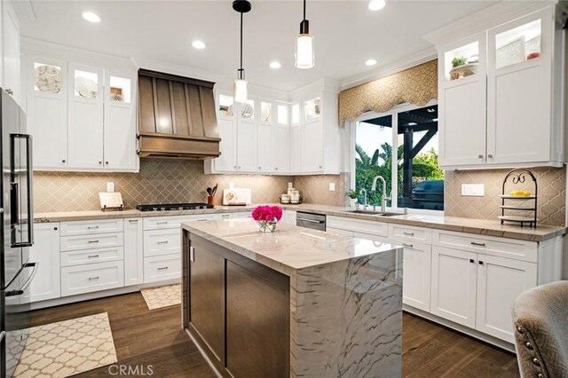 26238 Beecher Ln, Stevenson Ranch, CA 91381 - kitchen featuring premium range hood, gas stovetop, dark wood-type flooring, white cabinets, and a center island