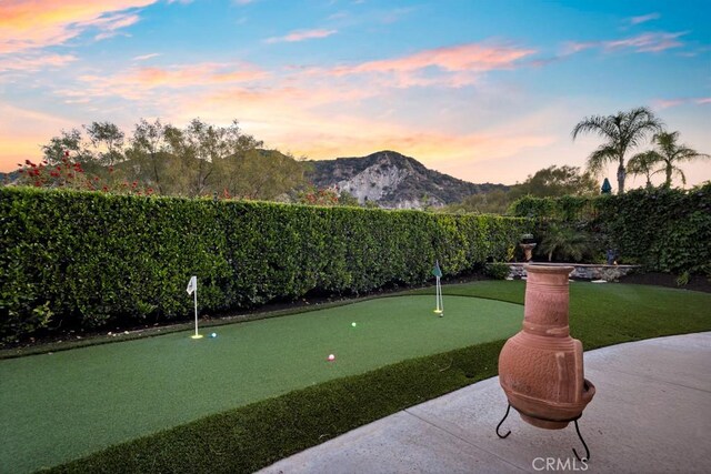 26238 Beecher Ln, Stevenson Ranch, CA 91381 - view of home's community with an area to practice putting, a mountain view, and a fenced backyard