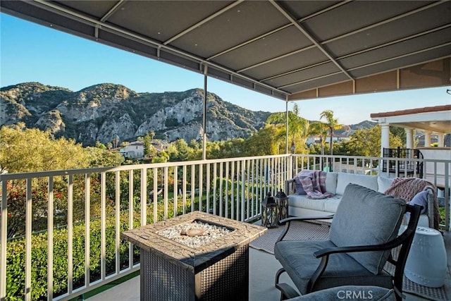 balcony featuring an outdoor living space and a mountain view