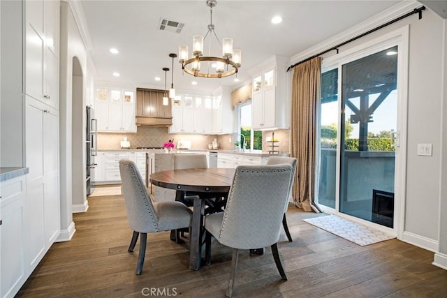 26238 Beecher Ln, Stevenson Ranch, CA 91381 - dining room with a chandelier, dark wood-style floors, recessed lighting, and crown molding