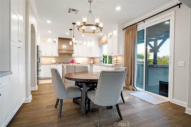 26238 Beecher Ln, Stevenson Ranch, CA 91381 - dining room with a chandelier, dark wood-style floors, recessed lighting, and crown molding