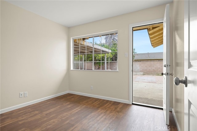 entryway with baseboards and wood finished floors
