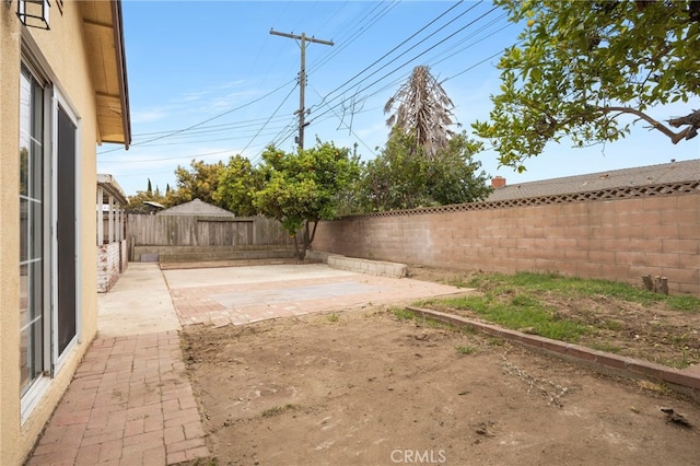 view of yard featuring a patio and a fenced backyard