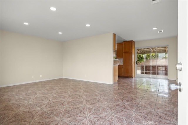 empty room with recessed lighting, baseboards, and visible vents
