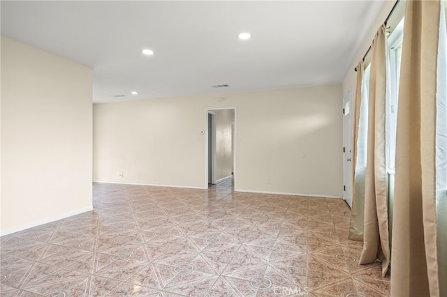 unfurnished room with recessed lighting and baseboards