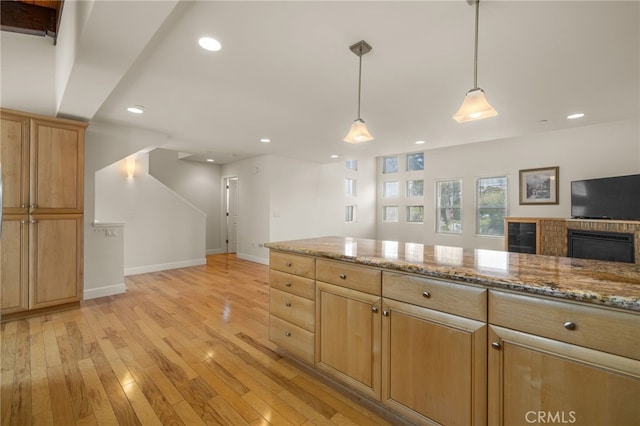 1210 Southwood Dr, San Luis Obispo, CA 93401 - kitchen with light stone countertops, recessed lighting, baseboards, light wood-type flooring, and pendant lighting