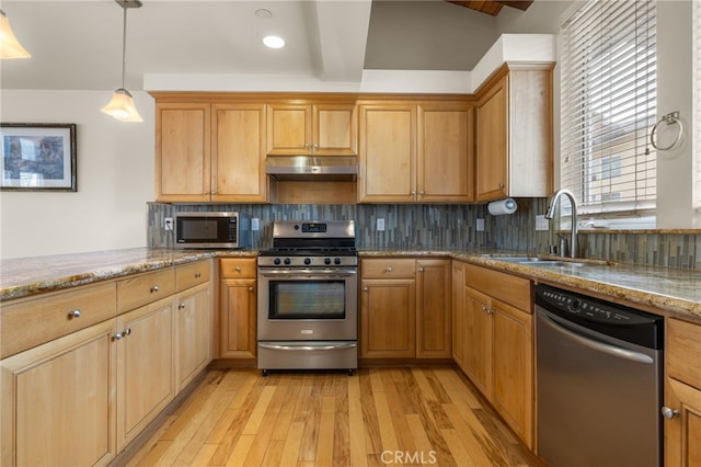 1210 Southwood Dr, San Luis Obispo, CA 93401 - kitchen featuring light wood-type flooring, under cabinet range hood, light stone counters, a sink, and stainless steel appliances