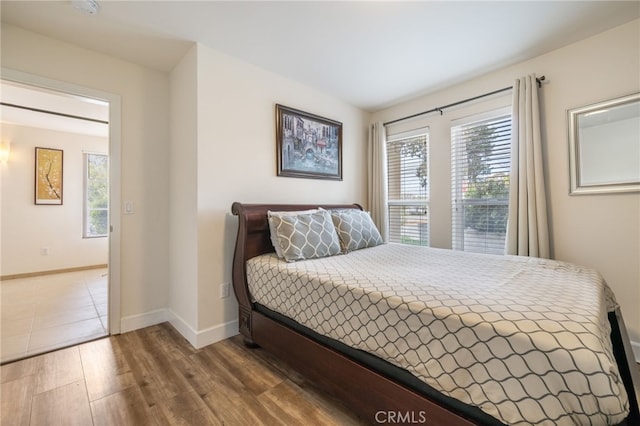 1210 Southwood Dr, San Luis Obispo, CA 93401 - bedroom featuring baseboards, multiple windows, and wood finished floors