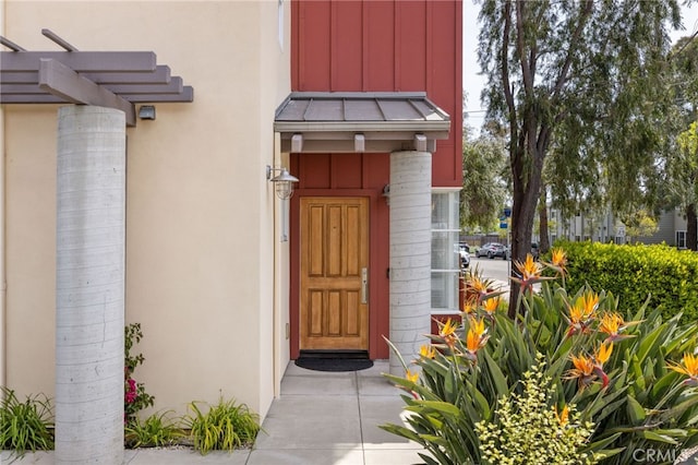 1210 Southwood Dr, San Luis Obispo, CA 93401 - property entrance featuring board and batten siding, stucco siding, metal roof, and a standing seam roof