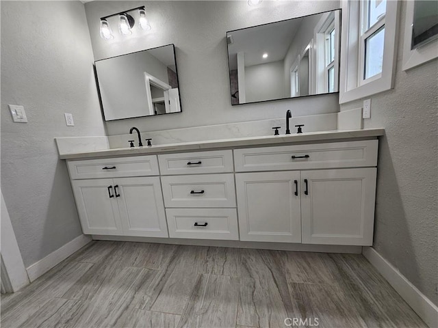3612 Liberty Blvd, South Gate, CA 90280 - full bath with double vanity, a textured wall, and baseboards