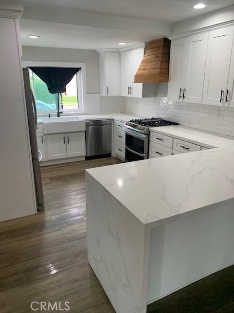 1613 Kane Ave, Simi Valley, CA 93065 - kitchen featuring custom range hood, appliances with stainless steel finishes, light stone counters, white cabinetry, and recessed lighting