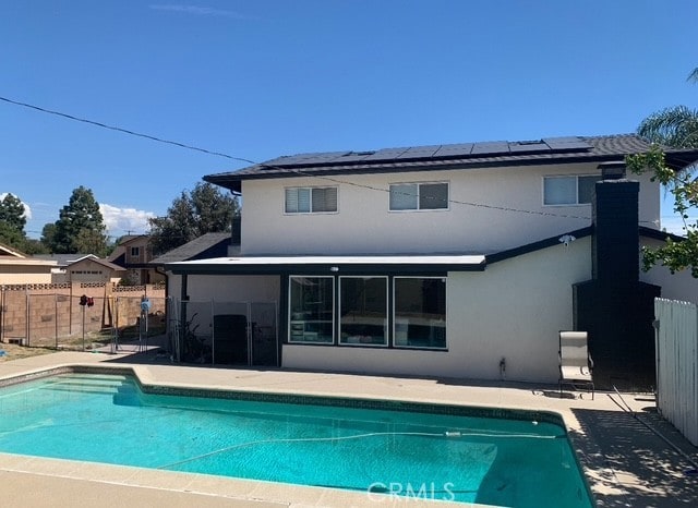 1613 Kane Ave, Simi Valley, CA 93065 - rear view of house featuring stucco siding, roof mounted solar panels, and a patio