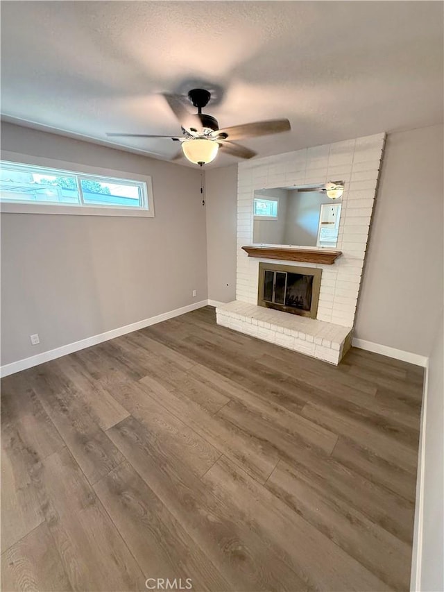 1613 Kane Ave, Simi Valley, CA 93065 - unfurnished living room with ceiling fan, dark wood-style flooring, a fireplace, and a textured ceiling