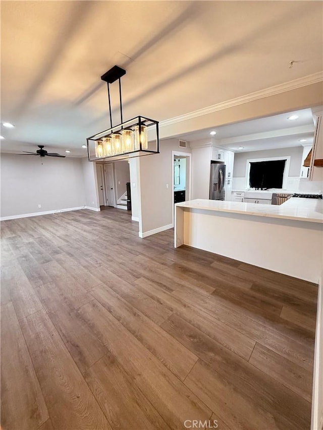 1613 Kane Ave, Simi Valley, CA 93065 - unfurnished living room with wood finished floors, stairway, recessed lighting, ceiling fan, and crown molding