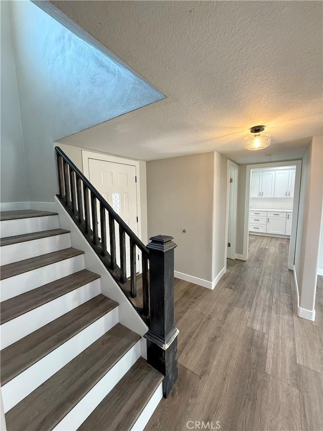 1613 Kane Ave, Simi Valley, CA 93065 - stairway featuring wood finished floors and a textured ceiling