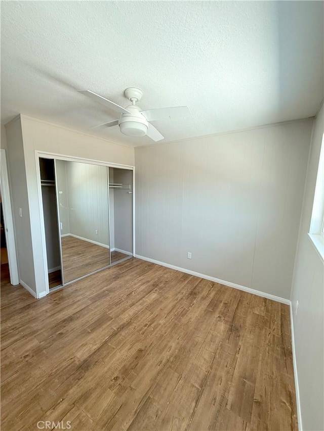 1613 Kane Ave, Simi Valley, CA 93065 - unfurnished bedroom featuring a closet, wood finished floors, a textured ceiling, and a ceiling fan