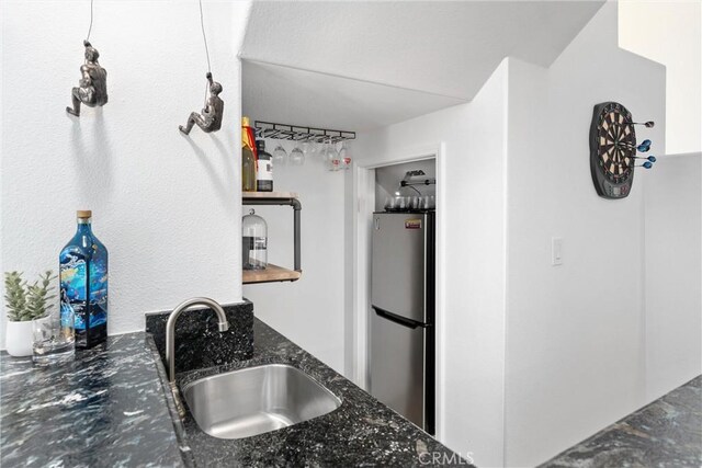 1720 San Alvarado Cir, Corona, CA 92882 - kitchen featuring freestanding refrigerator, a sink, and dark stone counters