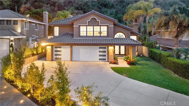 1720 San Alvarado Cir, Corona, CA 92882 - mediterranean / spanish house with driveway, a tiled roof, stucco siding, an attached garage, and a chimney