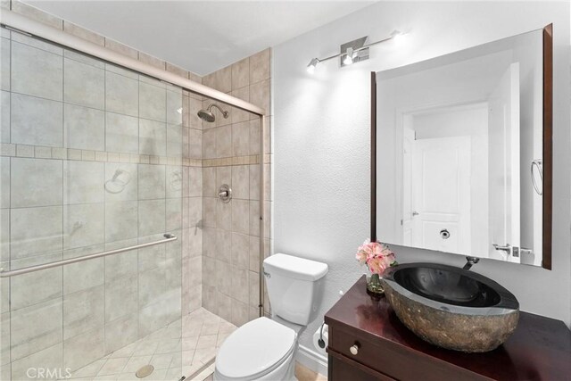 1720 San Alvarado Cir, Corona, CA 92882 - bathroom featuring a stall shower, toilet, and vanity