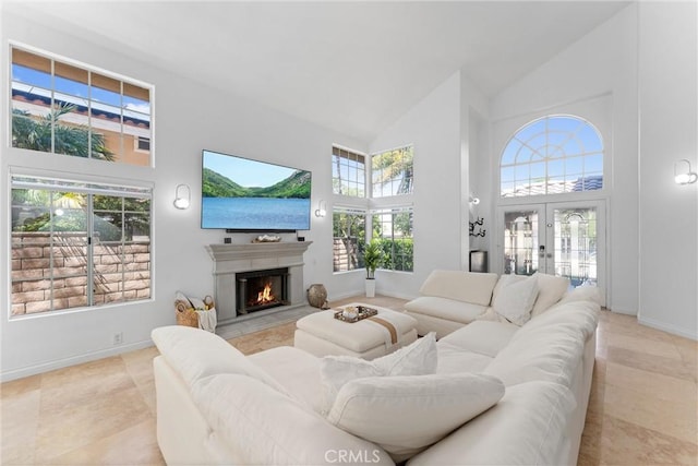 1720 San Alvarado Cir, Corona, CA 92882 - living room featuring high vaulted ceiling, a lit fireplace, light tile patterned flooring, french doors, and baseboards