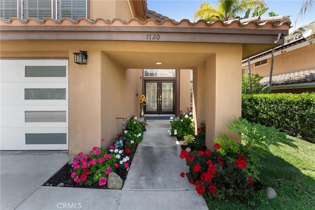 1720 San Alvarado Cir, Corona, CA 92882 - property entrance featuring french doors, stucco siding, a tile roof, and a garage