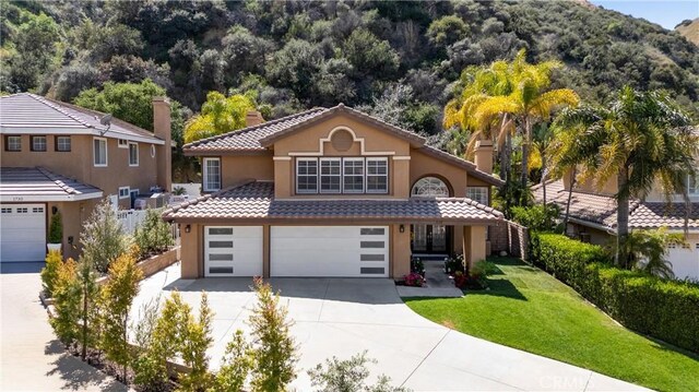 1720 San Alvarado Cir, Corona, CA 92882 - view of front of home with stucco siding, concrete driveway, a garage, a mountain view, and a tiled roof